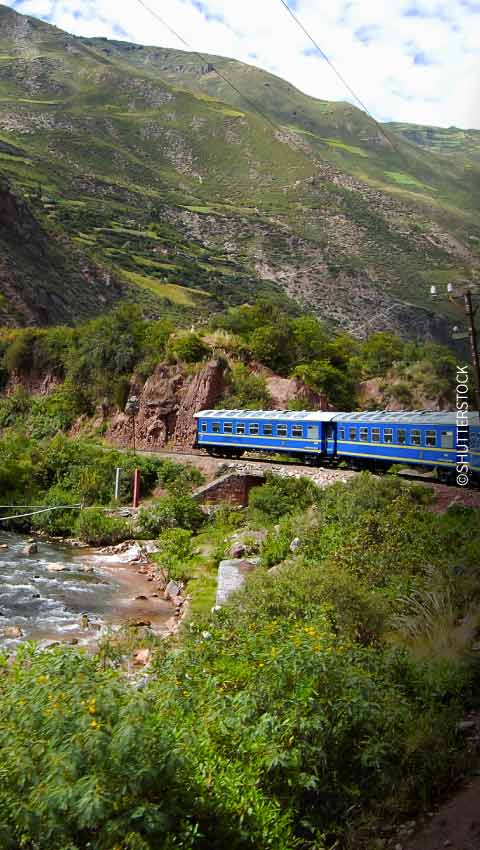 A traveler takes in the majestic Andean scenery during a rail journey through Peru