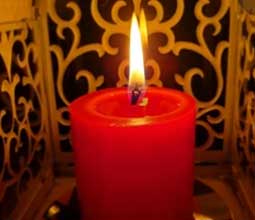 Red candle lit on May 1 for the anniversary of the Virgin of Chapi