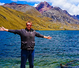 Tourist observing the lake near the mountains in Ancash