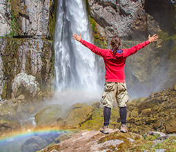 Tourist in front of waterfall in the Colca Valley