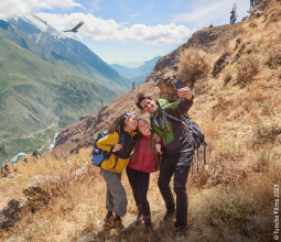 Gruppo di amici che fanno un selfie con un condor che vola sullo sfondo