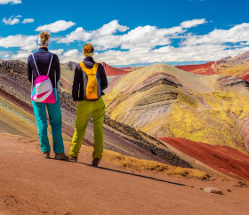 ourists enjoying views of Palccoyo Mountain in Cusco