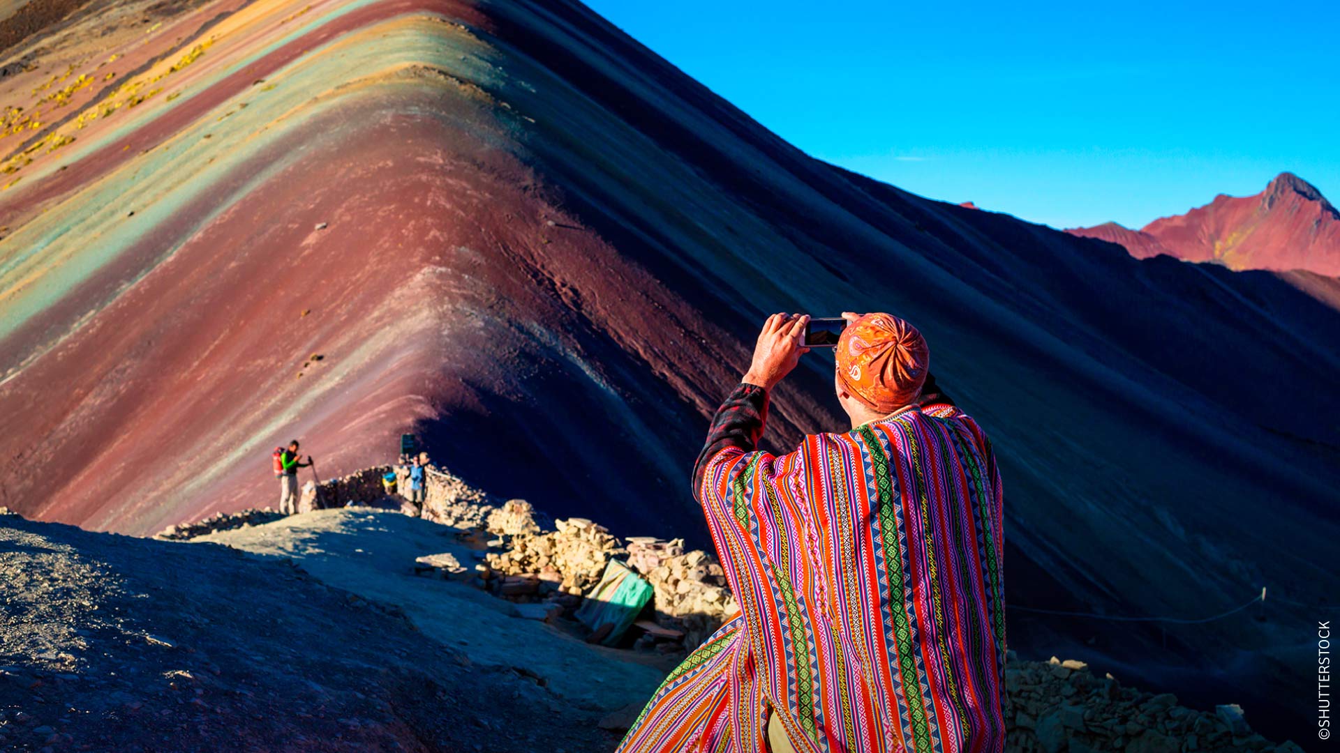Travelers capturing the beauty of Vinicunca, Cusco, Peru.