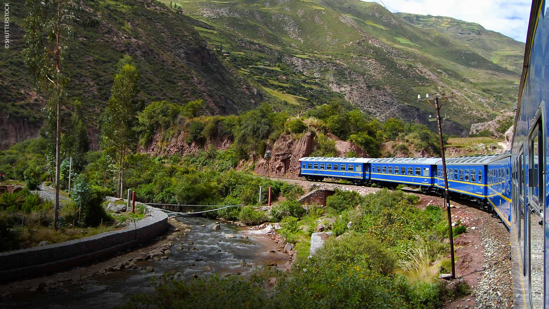 A traveler takes in the majestic Andean scenery during a rail journey through Peru