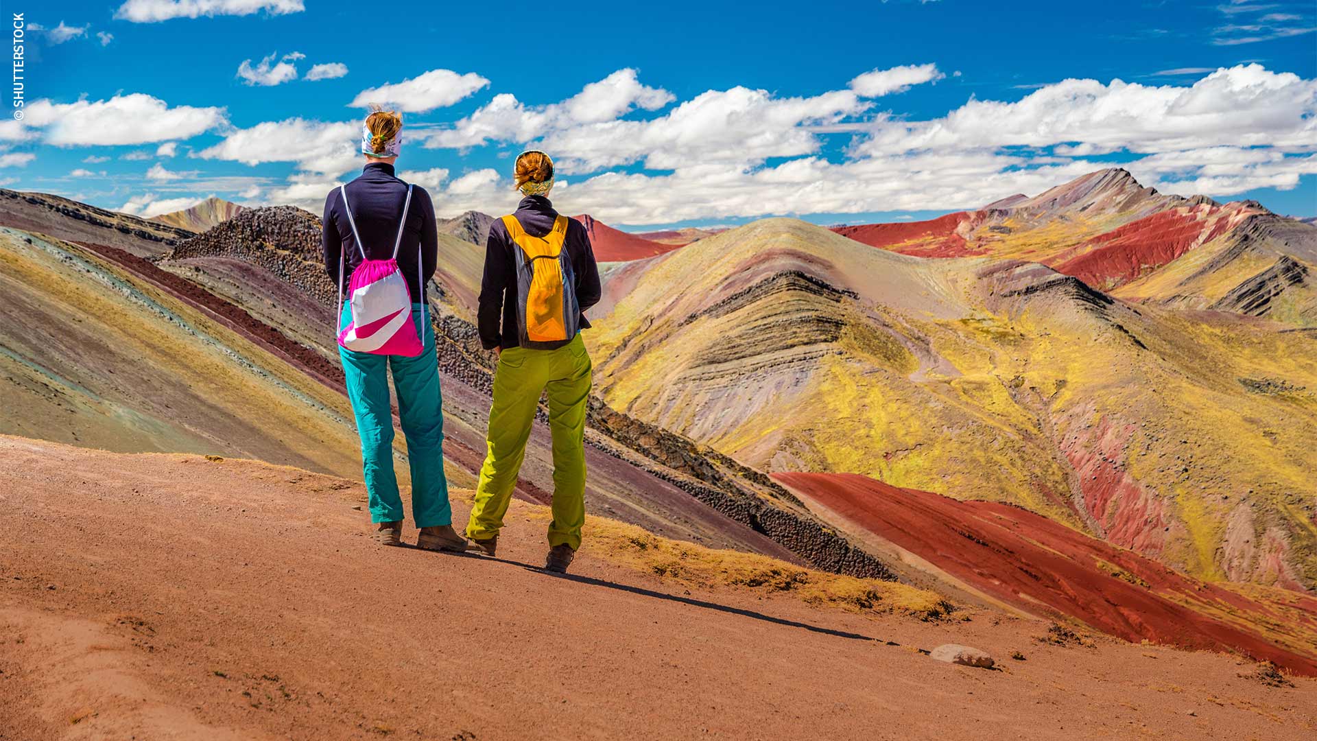 ourists enjoying views of Palccoyo Mountain in Cusco