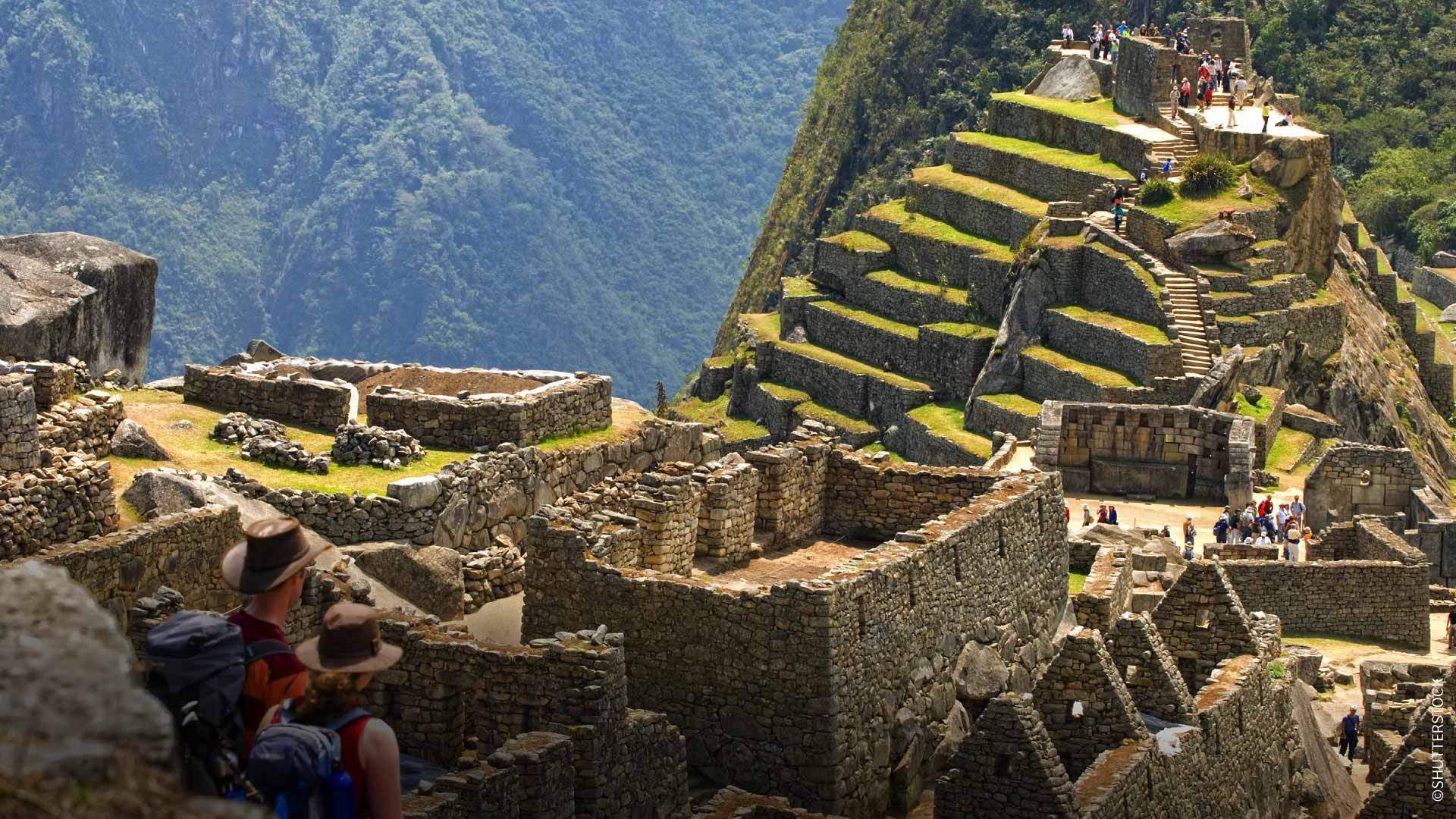 Couple admiring the view of the Historic Sanctuary of Machupicchu. Cusco, Peru.